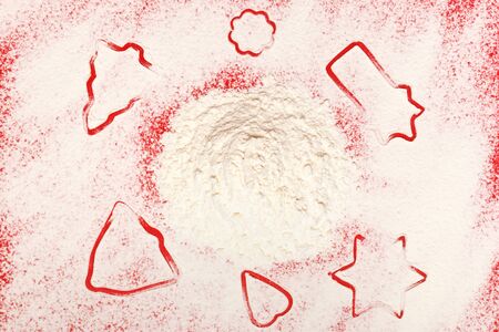 Christmas cookies. Star tree bell heart flour on a red background. Top view.の写真素材