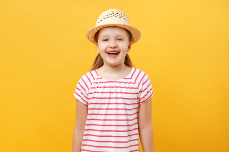 Closeup portrait of a child on a yellow background. Cheerful happy cute beautiful charming little...