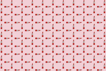Perpendicular geometric pattern of red lipstick on a pink background. Decorative cosmetics make-up.の写真素材