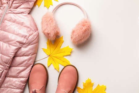 A set of warm autumn-winter clothes on a white background. Jacket boots headphones. Flat lay top view copy spaceの写真素材