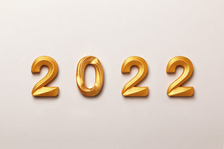 New Year composition with the inscription 2022 gold-colored numbers on a white background.の写真素材