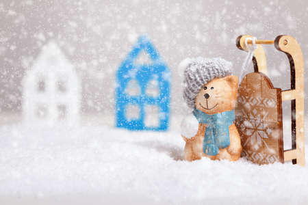 Winter Christmas composition. Toy cat with a sled in the snow.の写真素材