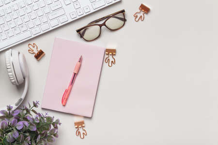 desktop business and education. Notepad keyboard cups coffee glasses glasses headphones on the table. Top view flat lay copy spaceの写真素材