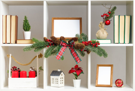 Decor home interior decoration for Christmas New Year. Book shelves flower pots spruce branches.