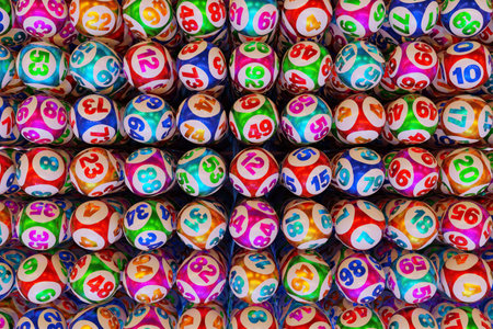 Many multi-colored lottery balls with numbers in a row. 3d renderingの写真素材