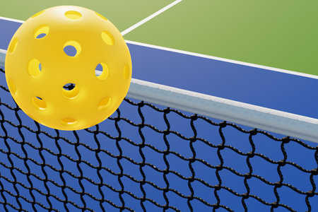 A pickleball ball flies over the court net. Close up 3d renderingの写真素材