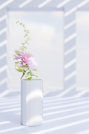 A beautiful flower arrangement in a white vase, illuminated by soft sunlight through window shadows. 3d renderingの写真素材