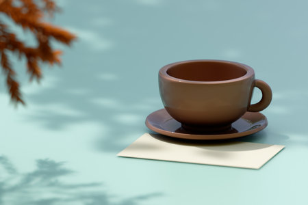 A brown coffee cup on a saucer sits on a blue table beside a blank paper under soft light. 3d renderingの写真素材