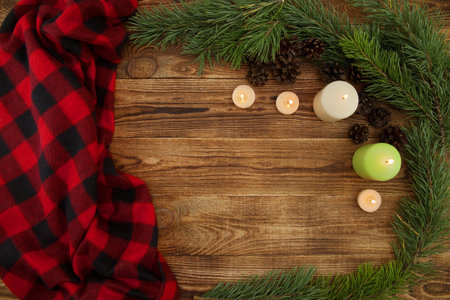 Christmas background, a composition of plaid, spruce, cones and a place for text on a wooden...