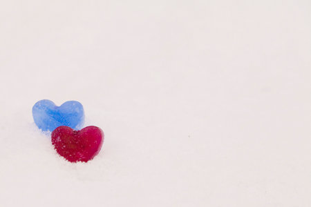 icy colored hearts on snow, valentine's day cardの写真素材