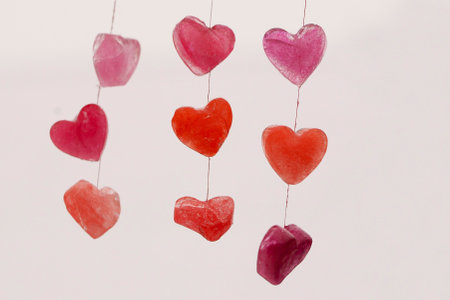 icy colored hearts hanging on branches, valentine's day cardの写真素材