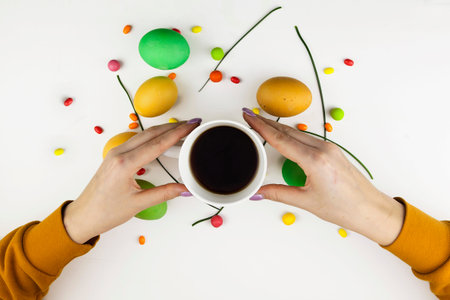 Easter background, woman holding a drink, against the background of multicolored Easter eggs and...
