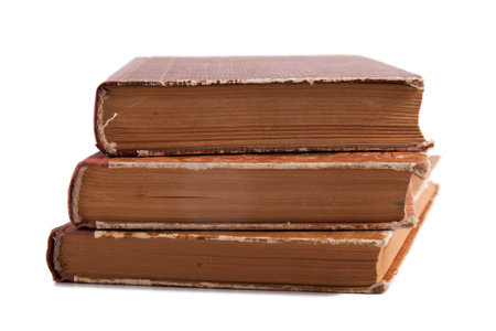 Old shabby books isolated on white backgroundの写真素材