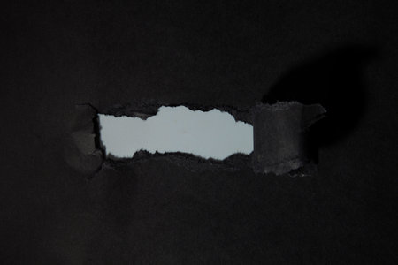 Black textured torn paper background for sale