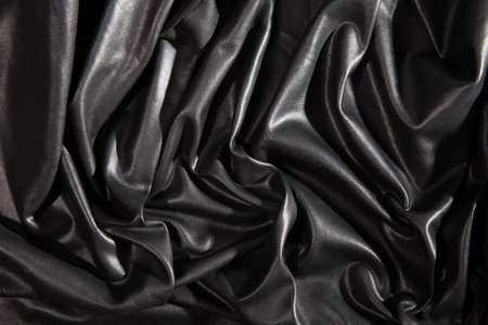 Black textured crumpled faux leather backgroundの写真素材