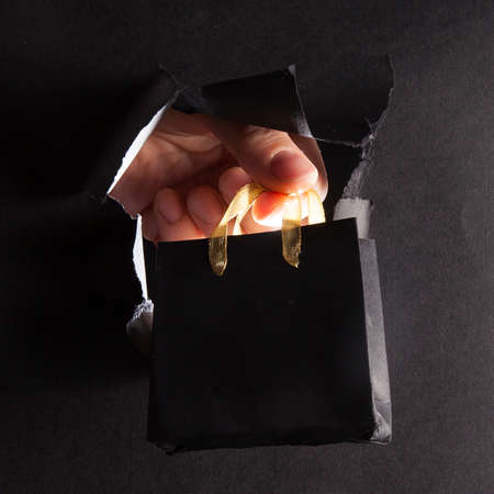 Black textured torn paper background for saleの写真素材