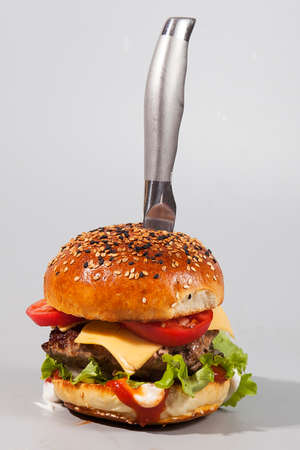 Fresh homemade burger with bun sprinkled with sesame seedsの写真素材