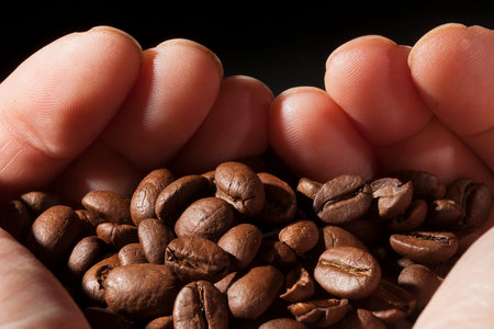 Beautiful background with coffee beans in dark colors
