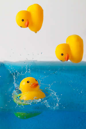 Yellow rubber ducks bathe, background for baby products for washingの写真素材