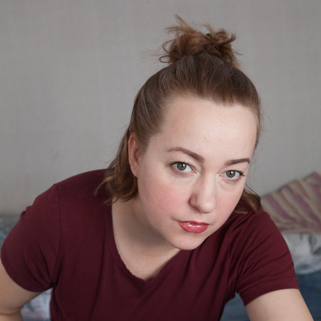 Portrait of a serious suspicious adult woman looking directly at the camera