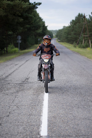 Motorcyclist outside the city, young man looking at the camera, Minusinsk. 02/07/2022