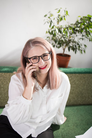 Portrait of an adult woman entrepreneur with grayish hair in a managerial position, dressed in a...