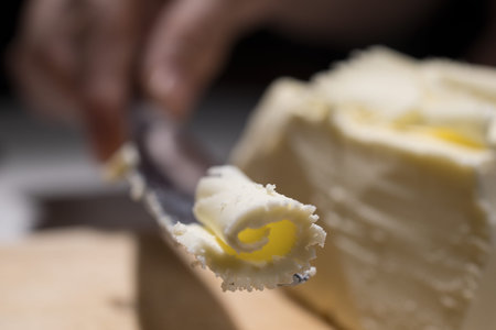 Cutting butCutting butter spread in sunlight shot close upter spread in sunlight shot close up