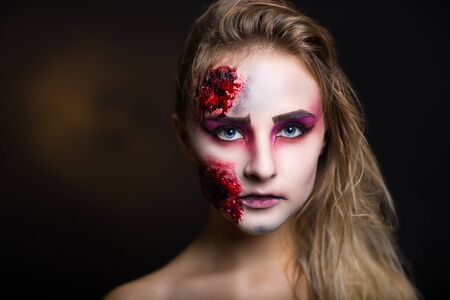 Pretty woman wound splinter in the skin, bloody part of face. Perfect new idea for advertisement, banner, Halloween party card. Cosplay idea beauty monster, sexy shoulders blood lips. Young white faceの写真素材