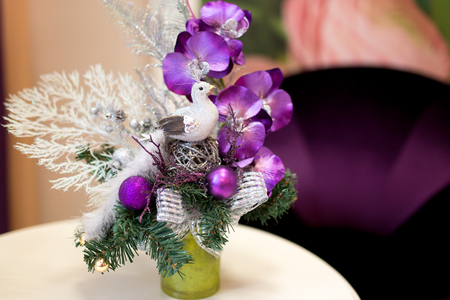 Decorative seasonal bouquet of flowers. Small bird in nest decorate perfect floral composition. A popular cultivated viola with flowers in rich colors, with both summer and winter flowering varieties.の写真素材