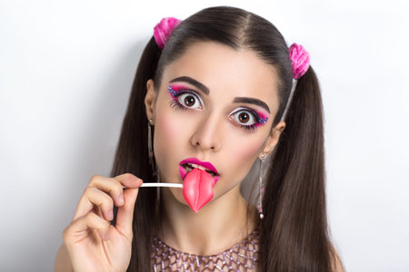 Portrait of beautiful young sexy lady, model, woman, actress, doll. Perfect makeup, long eyelashes, clean leather, gentle pink lips. Image can be used for advertising means skin care, cosmetic, suckの写真素材