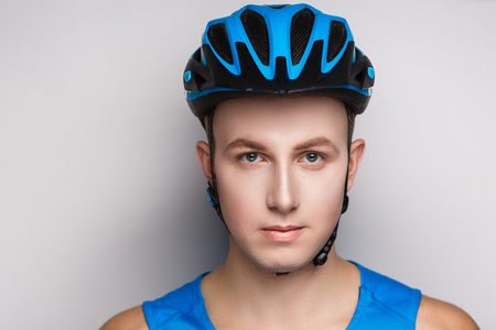 Handsome man in a blue helmet and bicycle goggles. Sports lifestyleの写真素材