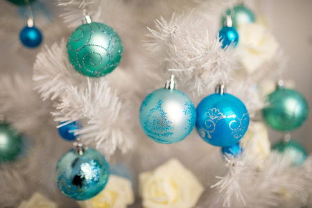 Beautiful decorations around x-mas trees fir-tree, happy New Year party. Santa Claus is coming, kids dreaming about presents, surprises. Shiny toys balls roses flowers bumps, blue white silver colorsの写真素材