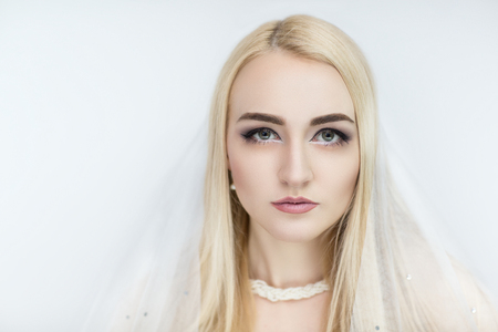 New perfect beautiful bride woman girl lady princess prepare for wedding. white long veil, white diamond necklace. Professional make up bright eyes, beige lips lipstick. background clippingの写真素材