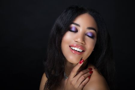 Closeup portrait beautiful girl woman lady, volume hair styling. Luxury brunette curly hair. Bright purple makeup, tender lipstick. Professional vip photo model. African American woman dark brown skinの写真素材