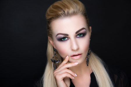 Closeup portrait beautiful girl woman lady with volume combed hair-do styling. Luxury blonde long hairstyle. Makeup matte lips lip-gloss lipstick, lashes. Professional photo model person horizontalの写真素材