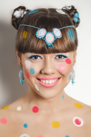 Creative make-up new conceptual idea. pink yellow white bold body painting. Crazy graphic abstract picture woman face surrealistic. professional photo. Creativity pop art circles. Positive lifestyleの写真素材