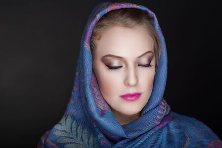 Young beautiful woman portrait. Christian religious scarf accessoryの写真素材