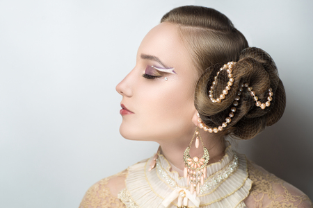 Closeup portrait of beautiful girl woman lady with professional make up and hair styling. Luxury accessory New Bright color makeup, shiny lipstick glossy cosmetics. Young pretty photo model vip personの写真素材