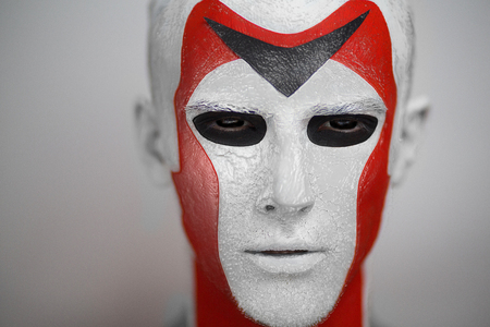 White & red man from Outer Space, Alien. Black eyes, white skin, red cheekbones, neck, ears Face art, decoration, geometry, cubism, full fashion look. Creative make up made by professional cosmetics.の写真素材