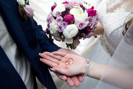 Two hands holding, man covers woman hand. Beautiful young couple, wedding romantic date. Sincere devotion feelings of love charm tenderness. social problem family, fidelity in marriage, conjugal dutyの写真素材