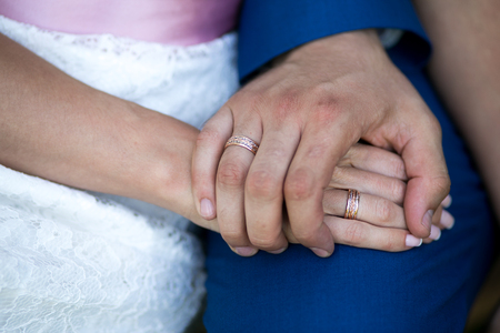 Two hands holding, man covers woman hand. Beautiful young couple, wedding romantic date. Sincere devotion feelings of love charm tenderness. social problem family, fidelity in marriage, conjugal dutyの写真素材