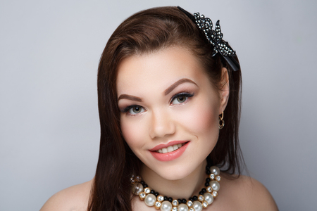 Closeup portrait beautiful girl woman lady with volume combed hair styling. Luxury brunette long hair, pin. Nude beige makeup tender lip-gloss new lipstick. Professional photo model person horizontalの写真素材