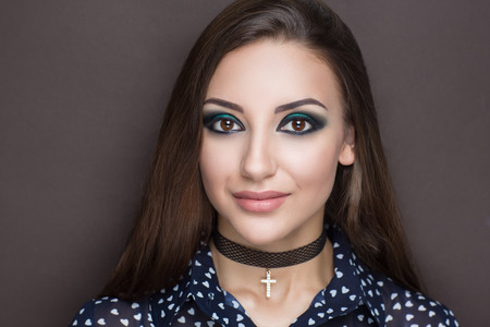 Closeup portrait of beautiful girl woman lady with professional make up and hair styling. Luxury accessory New Bright color makeup, shiny lipstick glossy cosmetics. Young pretty photo model vip personの写真素材