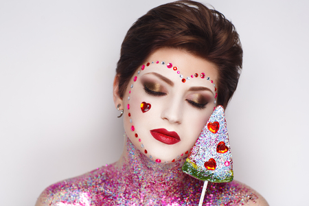 Creative make-up new conceptual idea. colorful bold faceart body art painting. Crazy new graphic abstract picture woman face surrealistic. professional photo. Creativity art lines concept perfectionの写真素材