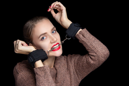 Sexy beautiful girl with a very triple face feels real fear because her hands are handcuffed for...