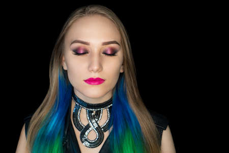 New creative make-up, conceptual art idea. Bronze shadows, vivid colors graphic shapes lines, cosmetics paints, big necklace jewelery. close-up photo. skin painting artistic. perfect straight hairの写真素材