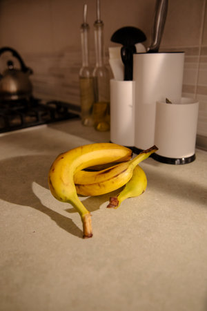 Ripe yellow banana, peeled banana, slices of ripe banana on the kitchen tableの写真素材