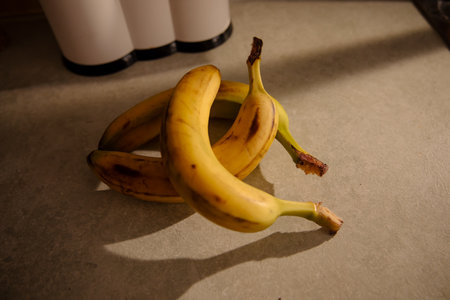 Ripe yellow banana, peeled banana, slices of ripe banana on the kitchen tableの写真素材