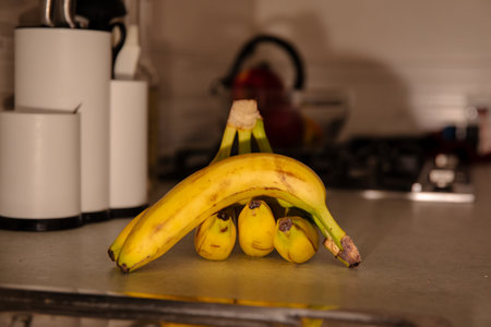 Ripe Bananas on a Table: Colorful and Healthy Fruit Stock Photographyの写真素材
