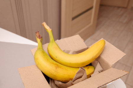 Banana fruit in a brown paper recycled boxの写真素材